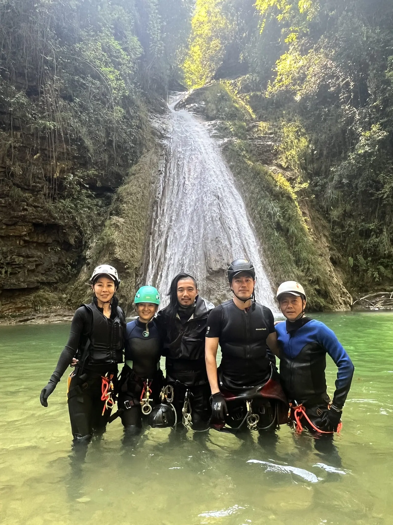 a group of clients smile for a photo with a canyon guide